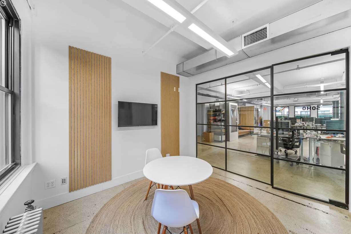 Glass front meeting nook with wood slat detailing